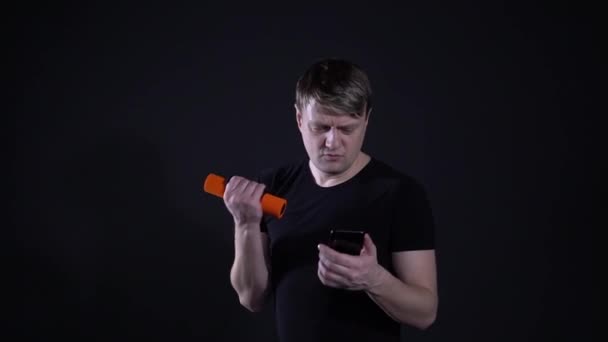 Muž čte Sms a bobs na černém pozadí — Stock video