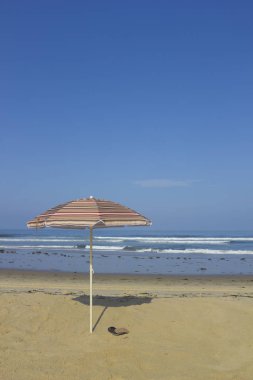 Plaj şemsiyesi ve sandal; boşaltmak