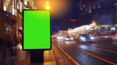 bir akşam sokaklarda yeşil bir ekran ile bir Pano