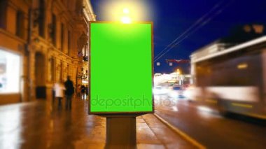 bir akşam sokaklarda yeşil bir ekran ile bir Pano