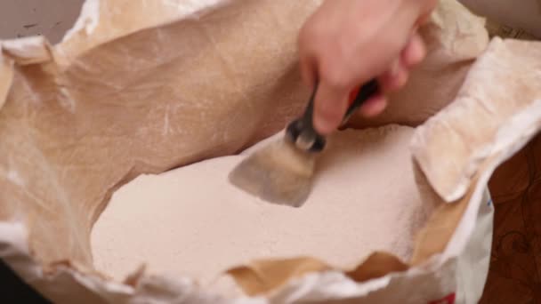 Worker Scoops Dry Plaster With a Spatula — Stock Video