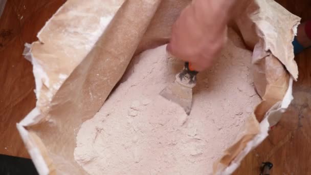 Εργαζόμενος κουταλιές ξηρό γύψο με μια σπάτουλα — Αρχείο Βίντεο