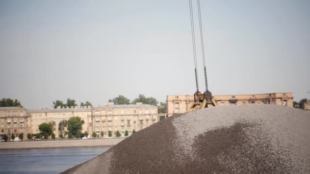 The Loading Crane Discharges Crushed Stone From the Barge to the Pier. — Stock Video