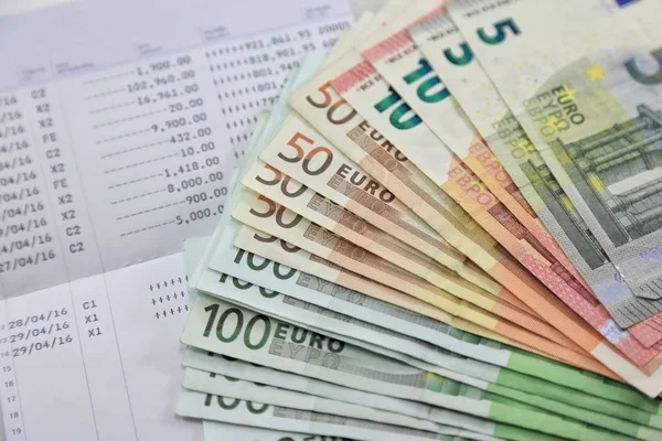 Many euro banknotes and bank account passbook show a lot of transactions. concept and idea of saving money, investment, interest, bank loan, inflation, expenses