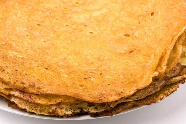 Thin pancakes on a white plate closeup — Stock Photo, Image