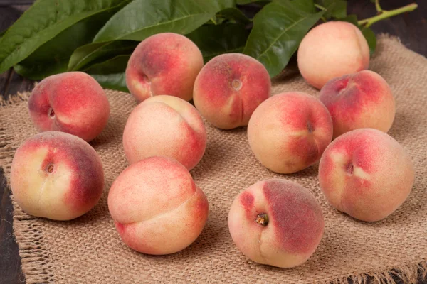 ahşap masa üzerinde bir hasır sepet şeftali