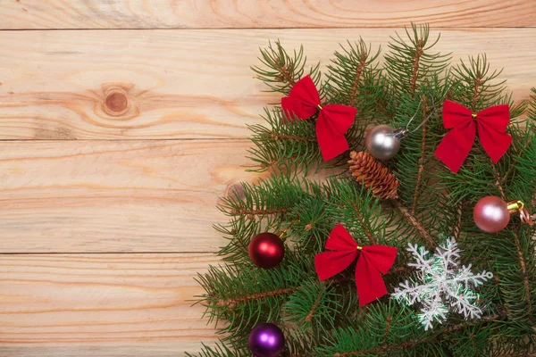 Noel köknar dalı hafif ahşap arka plan üzerinde dekore edilmiş