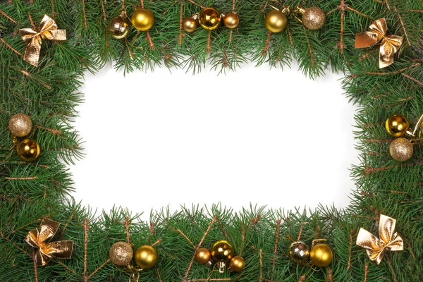 Moldura de Natal feita de ramos de abeto decorados com arcos e flocos de neve isolados no fundo branco — Fotografia de Stock