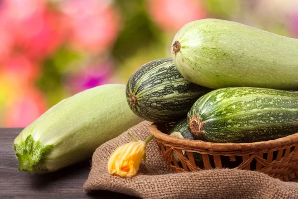Green zucchini and courgettes on sackcloth with a blurred background — Stock Photo, Image