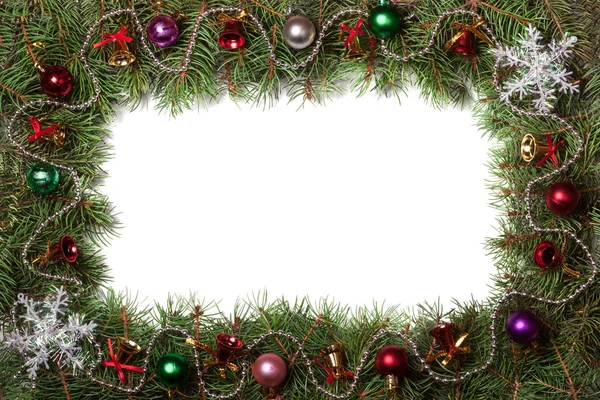 Moldura de Natal feita de ramos de abeto decorados com sinos e bolas isoladas no fundo branco — Fotografia de Stock