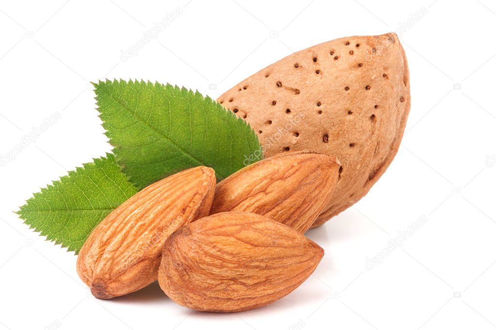 almonds in their skins and peeled with leaf isolated on white background