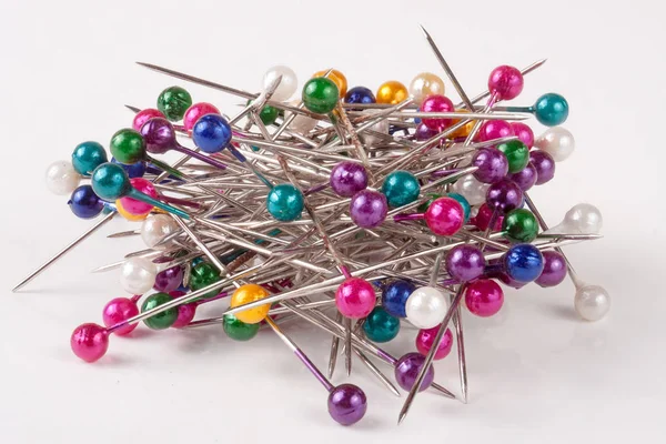 Pile of  multi-colored sewing pins on a white background — Stock Photo, Image