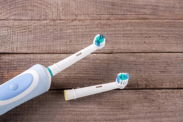 Electric Toothbrush on an old wooden background — Stock Photo, Image