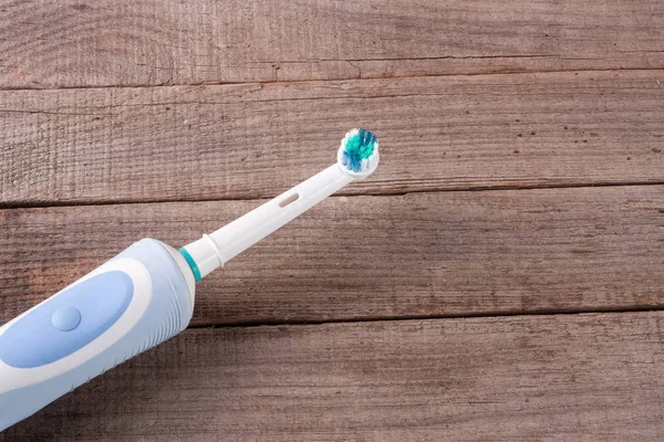 Electric Toothbrush on an old wooden background — Stock Photo, Image