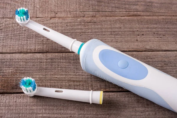 Electric Toothbrush on an old wooden background — Stock Photo, Image