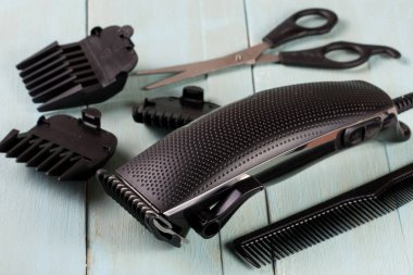 hair trimmer with comb and scissors on the wooden background clipart