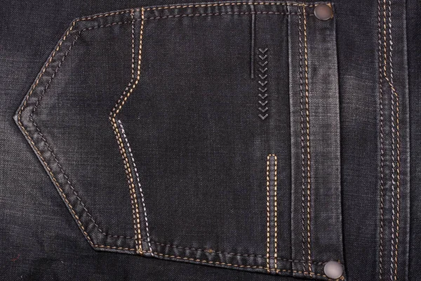 Back pocket of dark jeans close up — Stock Photo, Image