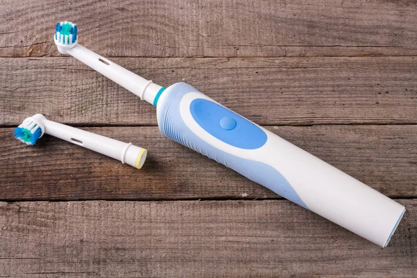 Electric Toothbrush on an old wooden background — Stock Photo, Image