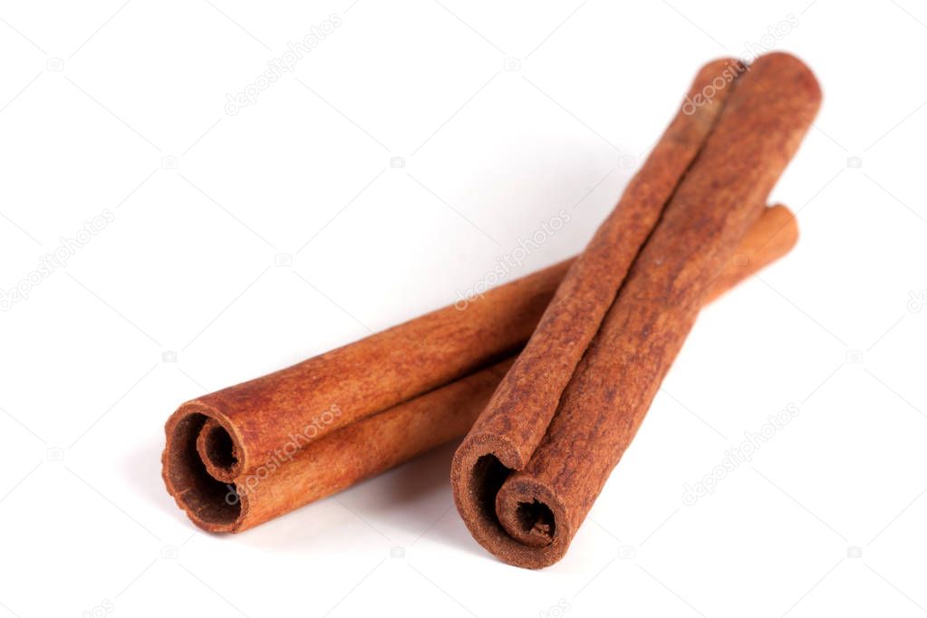 two cinnamon sticks isolated on white background