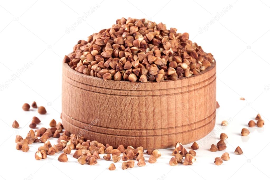 buckwheat in a wooden bowl isolated on white background