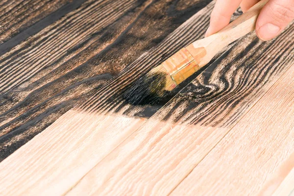 painting wooden board paint brush in black color