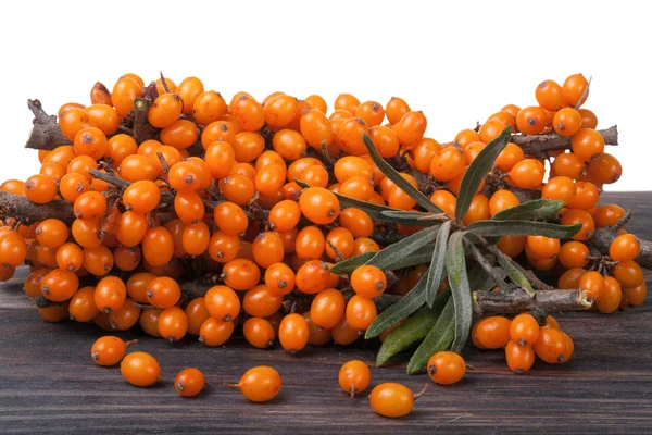 Sea buckthorn branch on a wooden table isolated  white background — Stock Photo, Image