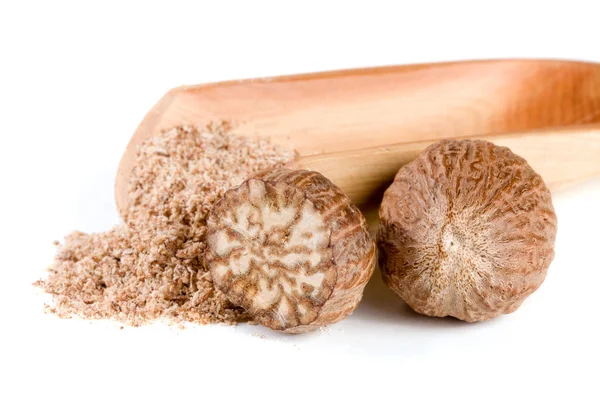 Two nutmeg and powder isolated on white background — Stock Photo, Image