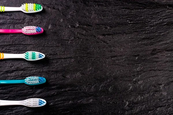 Manual toothbrushes on the black background with copy space for your text. Top view — Stock Photo, Image
