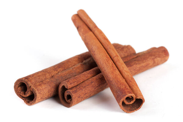 three cinnamon sticks isolated on white background