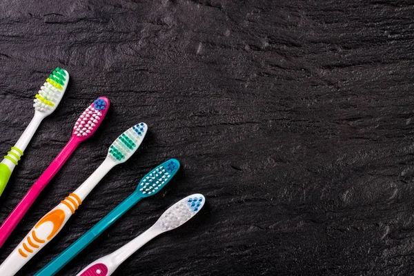 Manual toothbrushes on the black background with copy space for your text. Top view — Stock Photo, Image