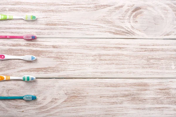 Manual toothbrushes on the old wooden background with copy space for your text. Top view — Stock Photo, Image