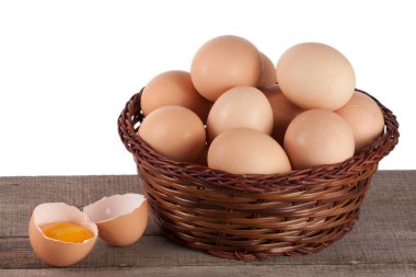 yumurta bir hasır sepet beyaz zemin üzerinde bir ahşap tablo