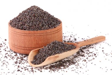 ahşap kase ve beyaz arka plan üzerinde izole Kepçe haşhaş tohumu