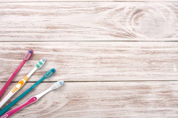 Manual toothbrushes on the old wooden background with copy space for your text. Top view — Stock Photo, Image