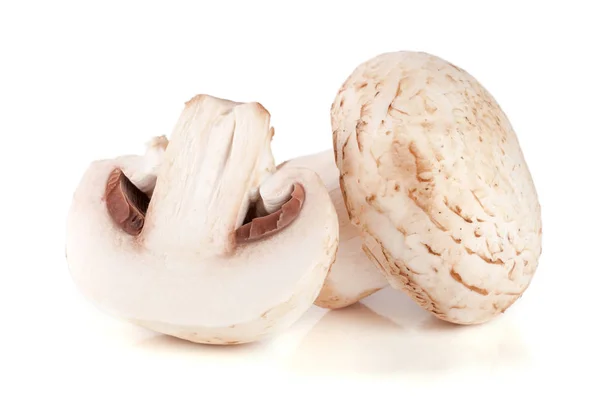 Champignon mushrooms and half isolated on white background Stock Picture