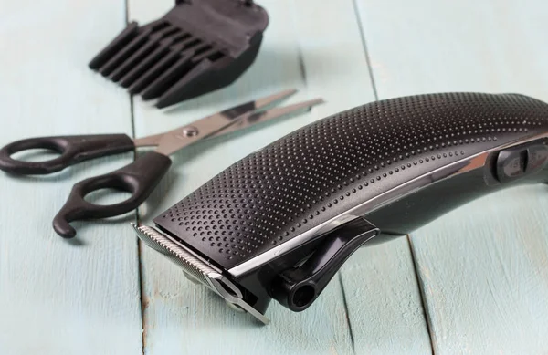 hair trimmer with scissors on the wooden background