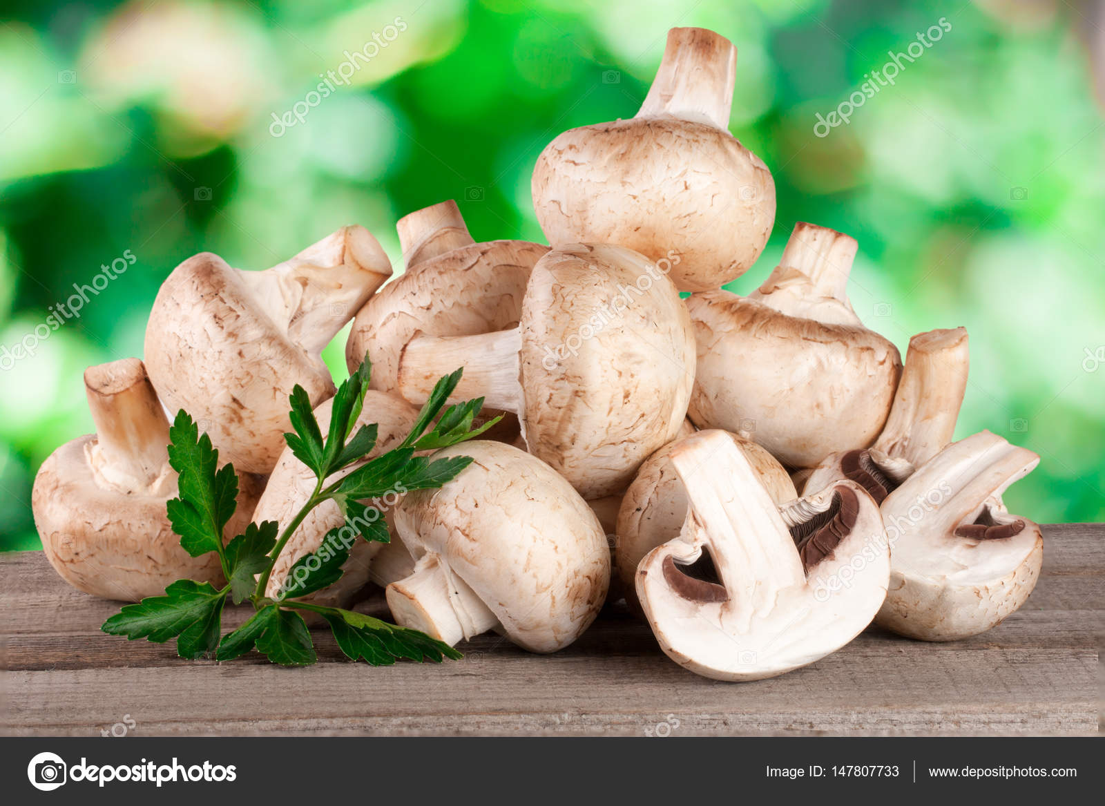 Champignon Mushrooms On Wooden Table With Blurred Garden