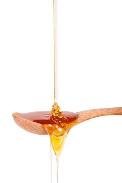 Honey in a wooden spoon isolated on a white background — Stock Photo, Image