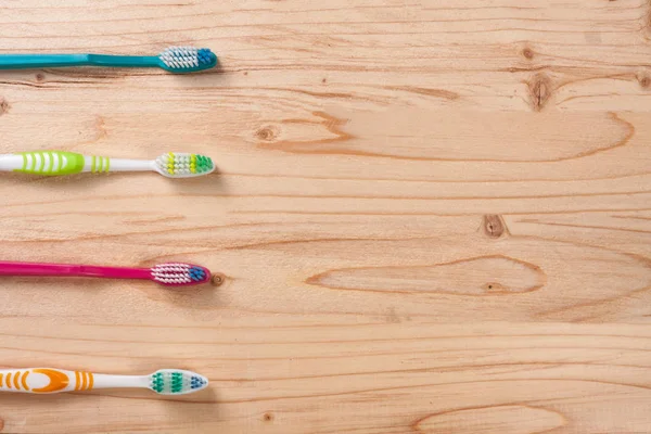 Toothbrushes on the light wooden background with copy space for your text. Top view — Stock Photo, Image