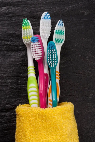 Toothbrushes on the black stone background — Stock Photo, Image