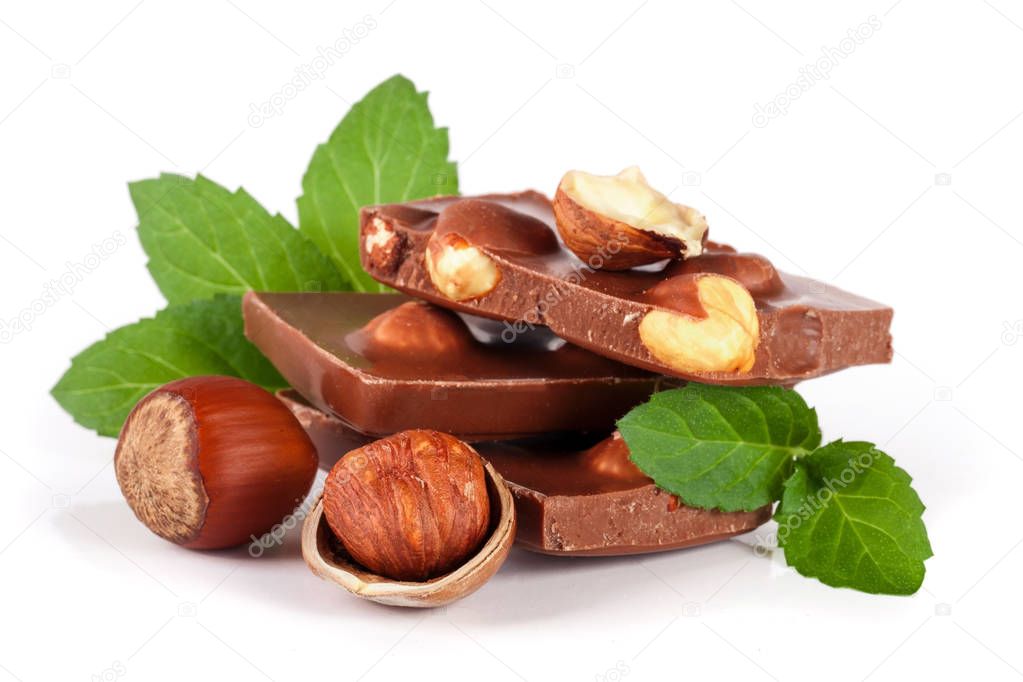 Chocolate with hazelnut and mint leaf isolated on white background