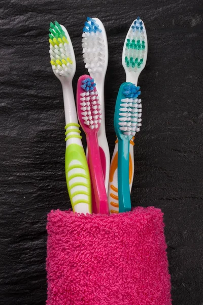 Toothbrushes on the black stone background — Stock Photo, Image
