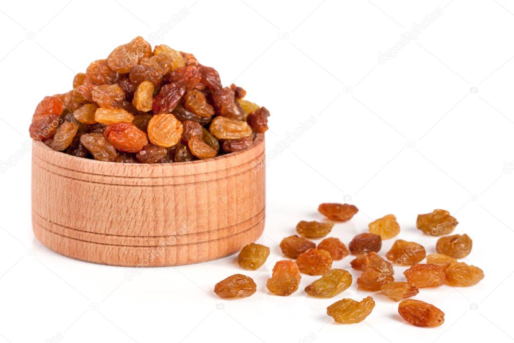 raisins in a wooden bowl isolated on white background