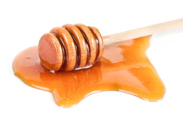 Mel stick com mel fluindo isolado no fundo branco — Fotografia de Stock