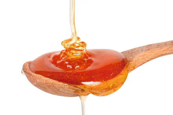 Med v dřevěnou lžící izolovaných na bílém pozadí — Stock fotografie