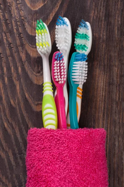 Toothbrushes on the black wooden background — Stock Photo, Image