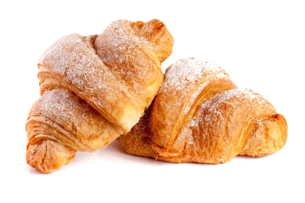 Due croissant cosparsi di zucchero a velo isolato su fondo bianco primo piano — Foto Stock