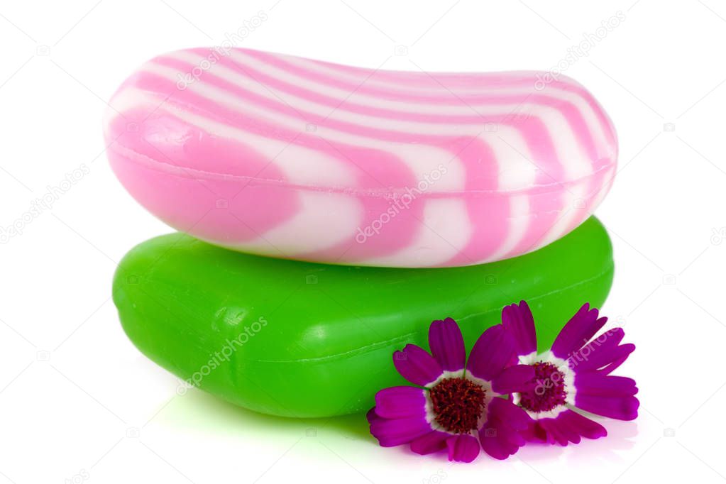 Two multi-colored striped soaps with a flower isolated on white background