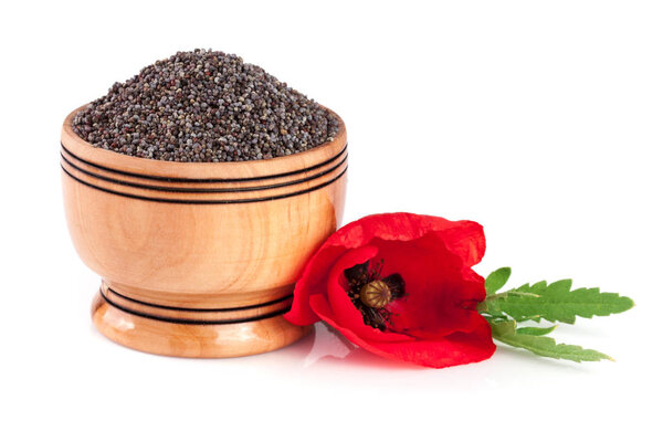 Poppy seeds in a wooden bowl with a flower