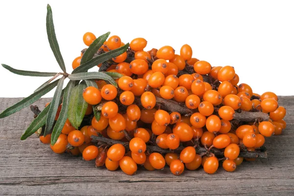 Sea buckthorn branch on a wooden table isolated white background — Stock Photo, Image